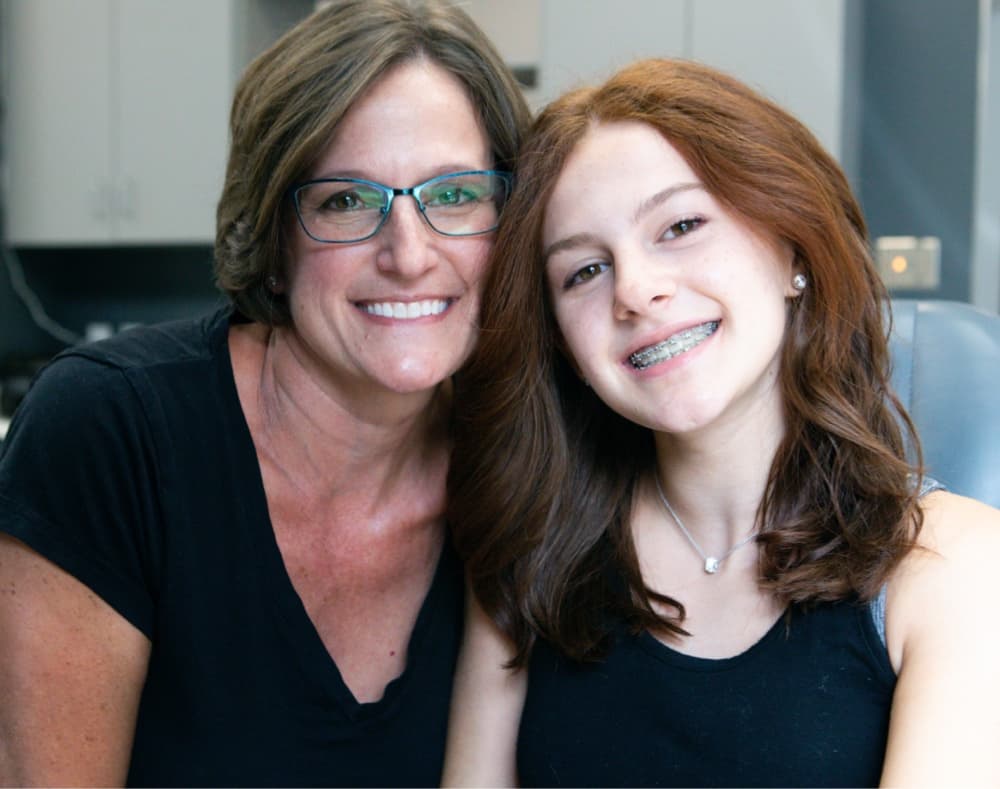 teen patient and team member smiling during visit