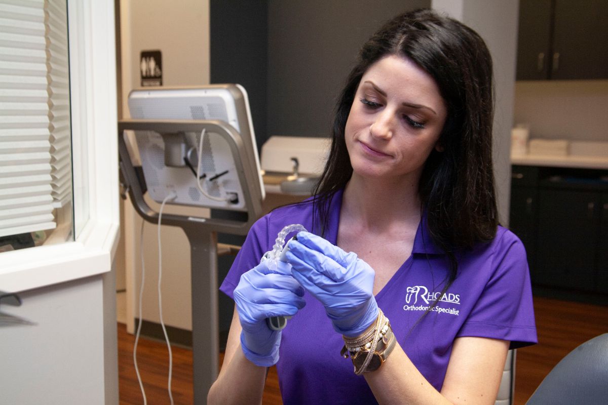 Rhoad's assistant filing Invisalign trays